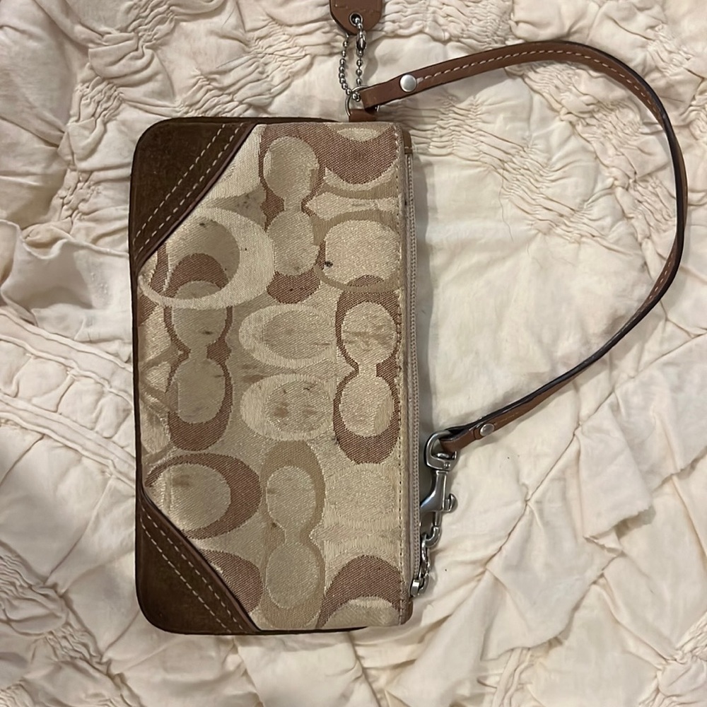 Coach zipper wristlet in brown.